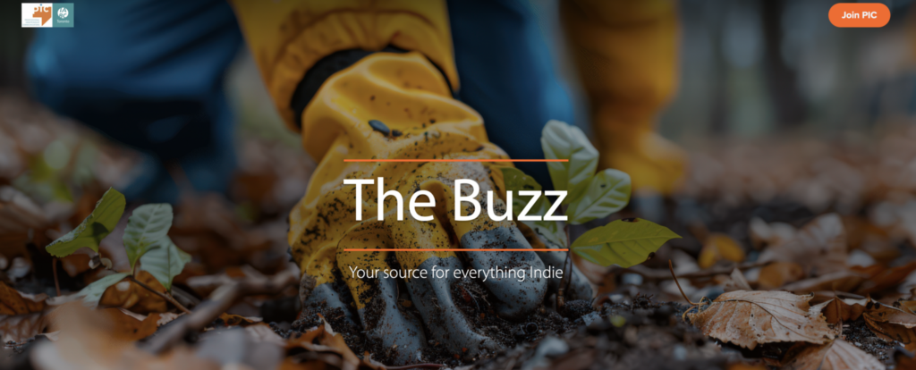 A hand in a yellow and blue rubber glove piles earth around a plant amid fallen leaves and twigs. Text reads, “The Buzz. Your source for everything indie.” The PIC and IABC/Toronto logos are on the top left and a button that says “Join PIC” is top right.